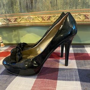 Carlos Santana patent pumps with ruffle